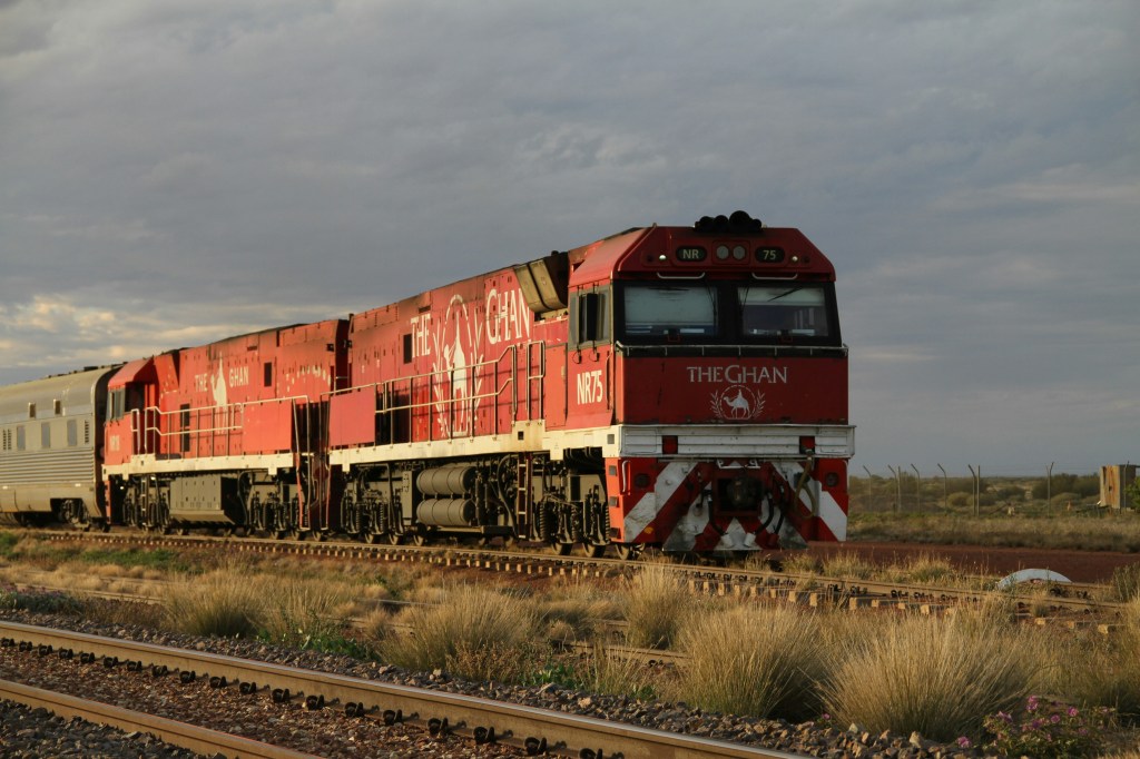 he Ghan luxury train traveling through the red desert of the Australian Outback