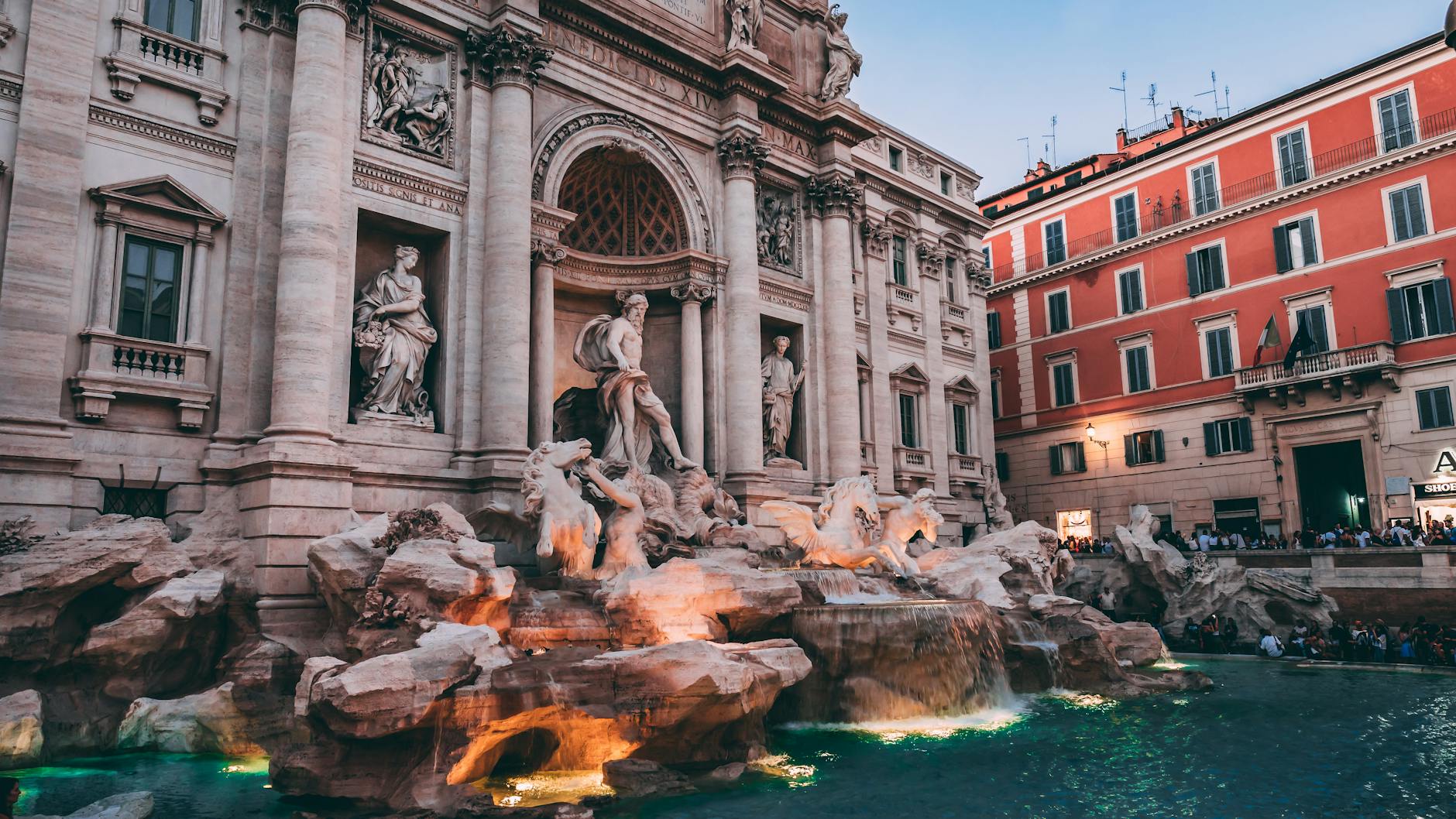 Trevi Fountain in Rome with tourists tossing coins into the water