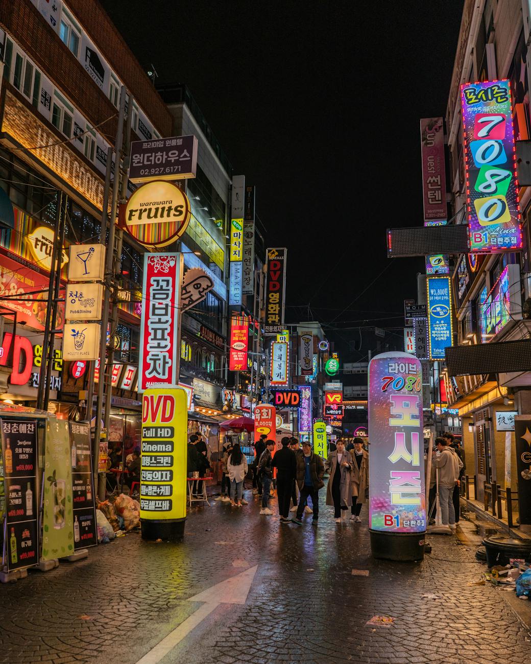Neon-lit streets of Myeongdong, Seoul bustling with night shoppers