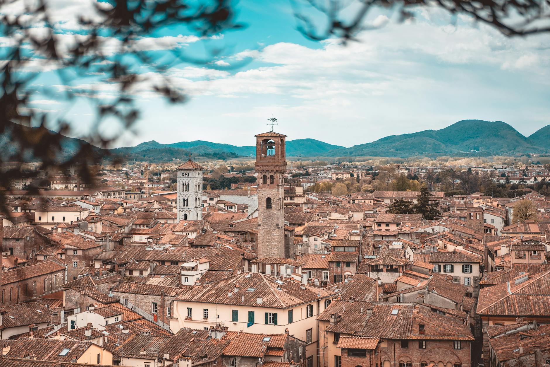 Aerial view of Lucca city with medieval walls and red rooftops in Tuscany, Italy