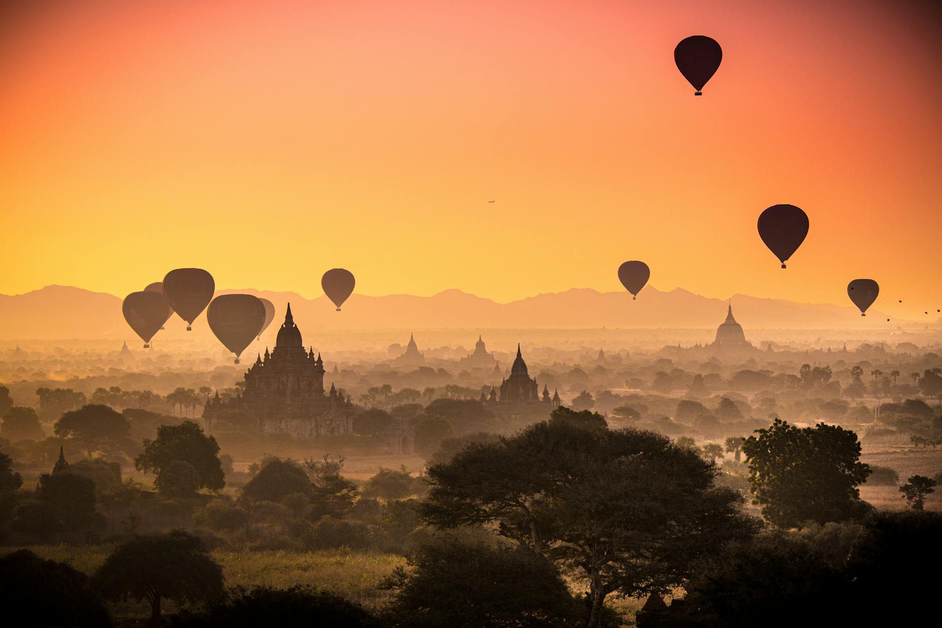 Hot air balloons floating over ancient temples of Bagan at sunrise, Myanmar