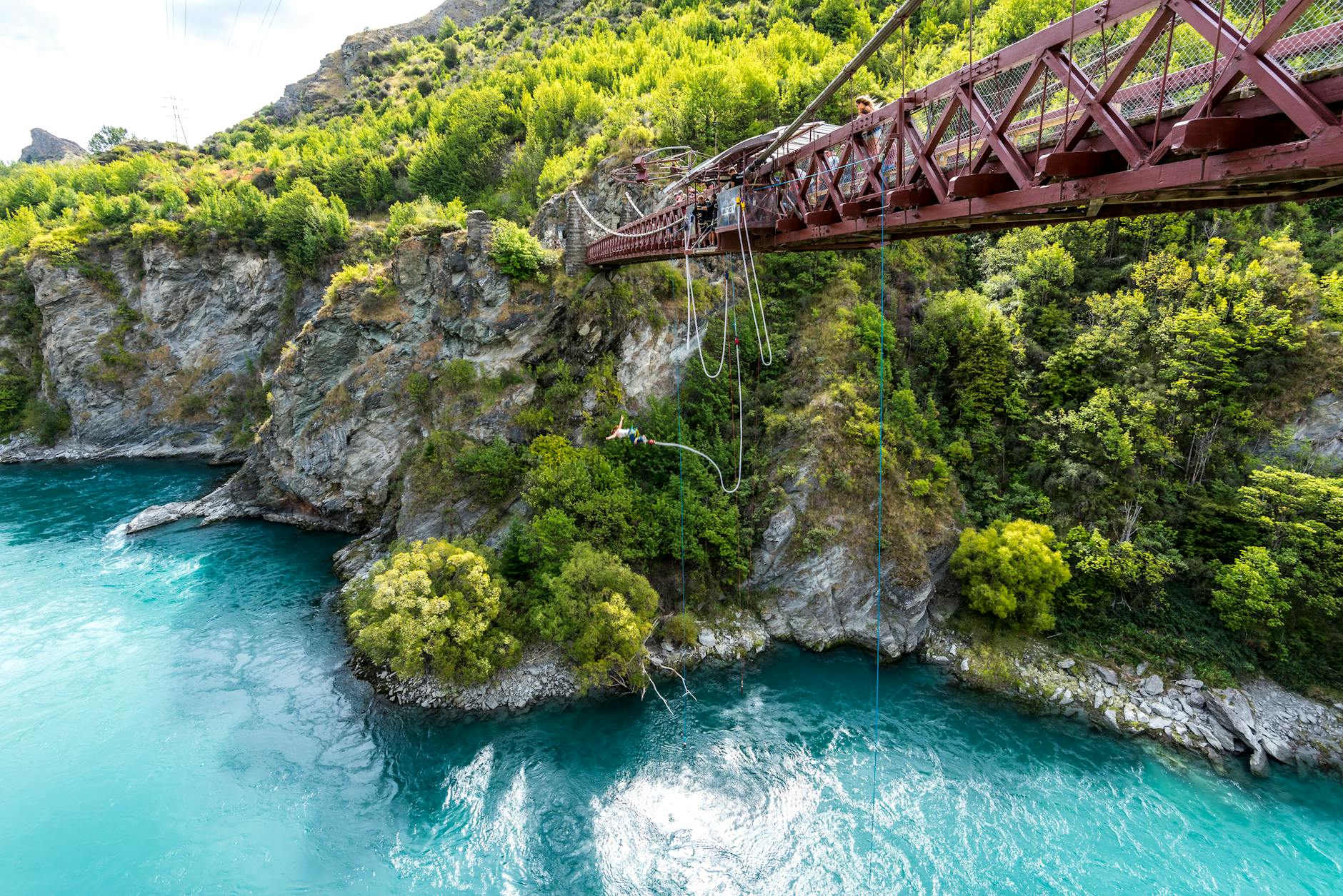 Kawarau Suspension Bridge in Queenstown surrounded by rugged cliffs and river views