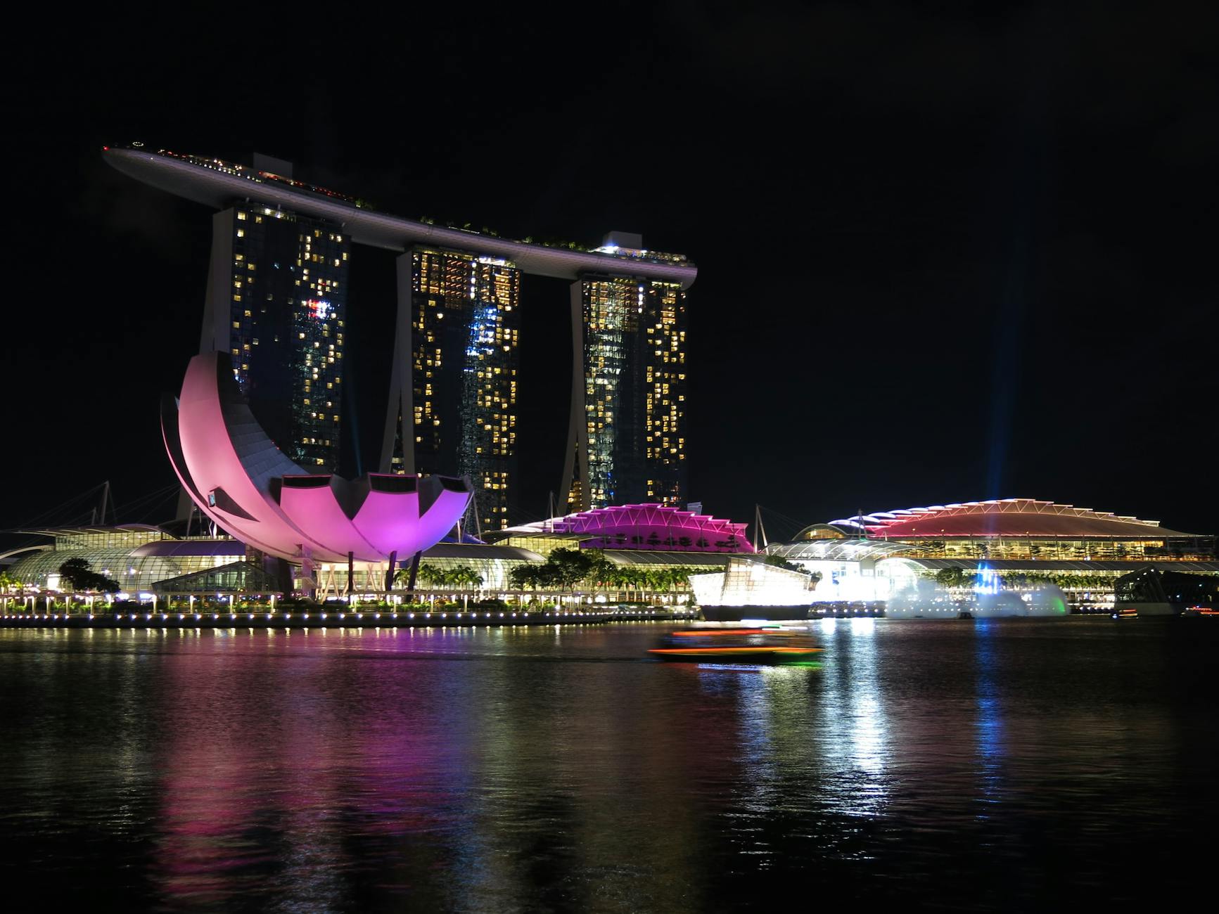 Singapore skyline illuminated at night with Marina Bay Sands and city lights