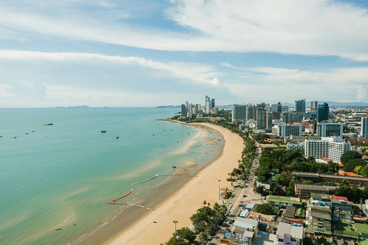 Pattaya beachfront view showing tropical coastline and city skyline near Wisdom Valley festival venue.