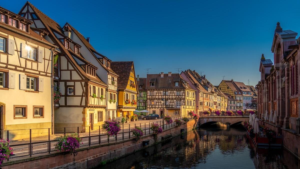 Picturesque half-timbered houses and reflective canals in Petite Venise, Colmar, for a fairytale French escape.